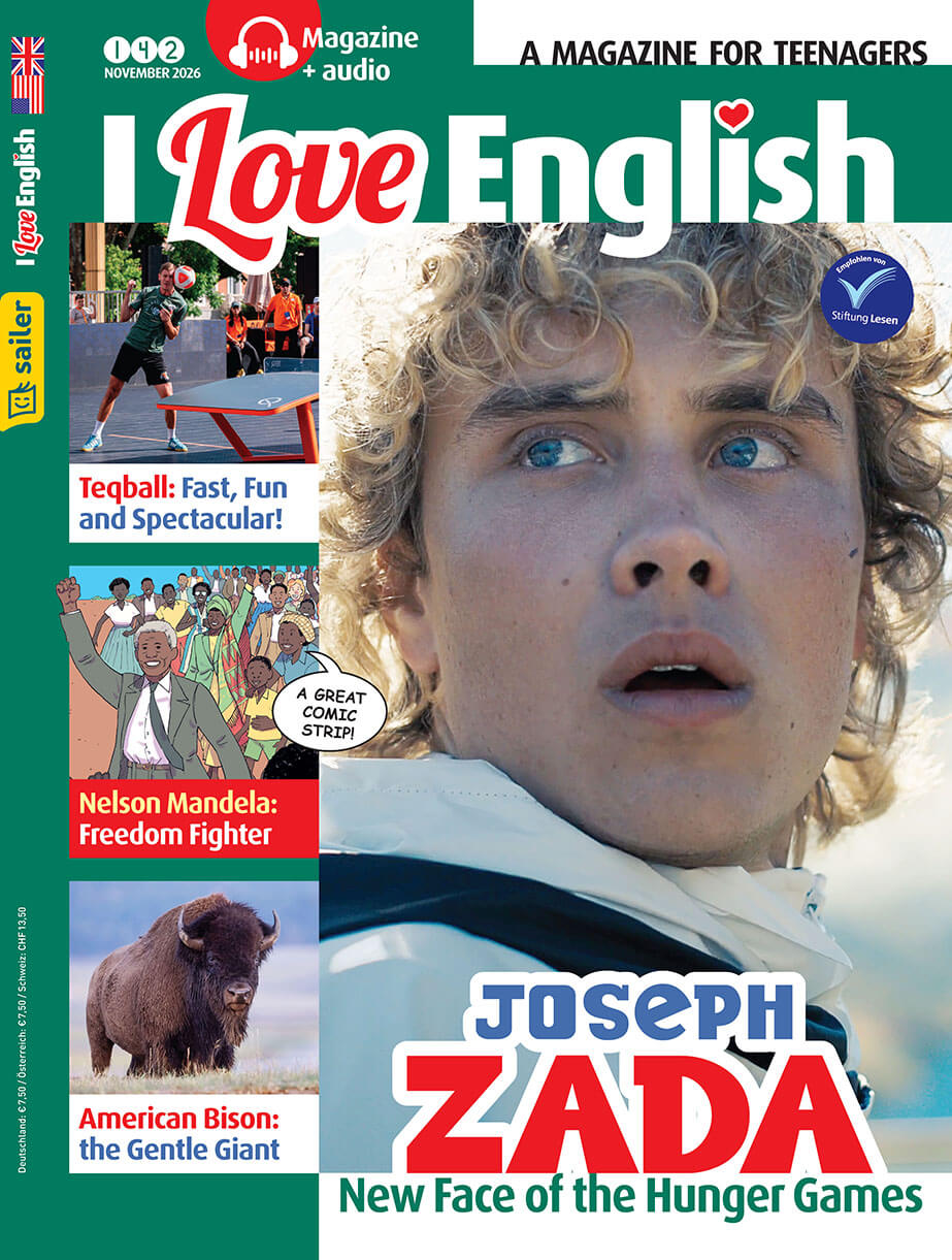 Titelseite der Zeitschrift 'I Love English' Ausgabe 142, November 2026. Im Vordergrund ein junges Gesicht mit lockigem blonden Haar. Der Text auf dem Cover lautet: 'Joseph Zada, New Face of the Hunger Games'. Links oben das Logo von Sailer Verlag. Links sind Themen der Ausgabe aufgelistet: 'Teqball: Fast, Fun and Spectacular!', 'Nelson Mandela: Freedom Fighter', 'American Bison: the Gentle Giant'.